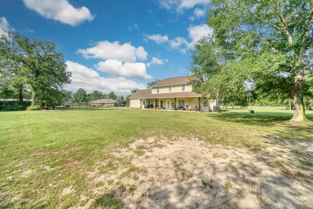a view of a house with yard and front view of a house