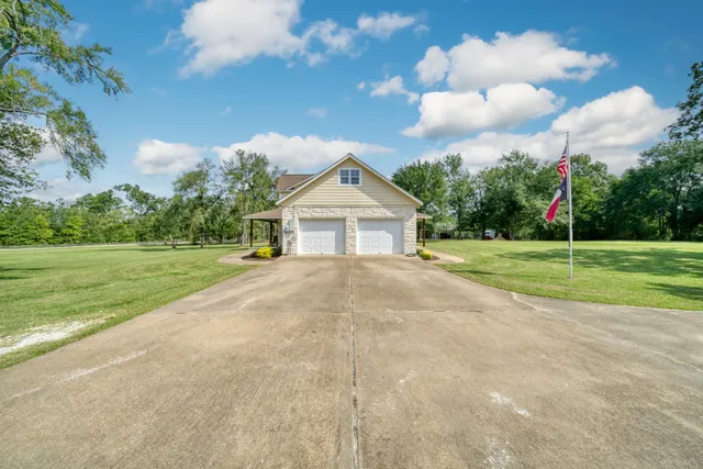 a view of house with backyard and garden