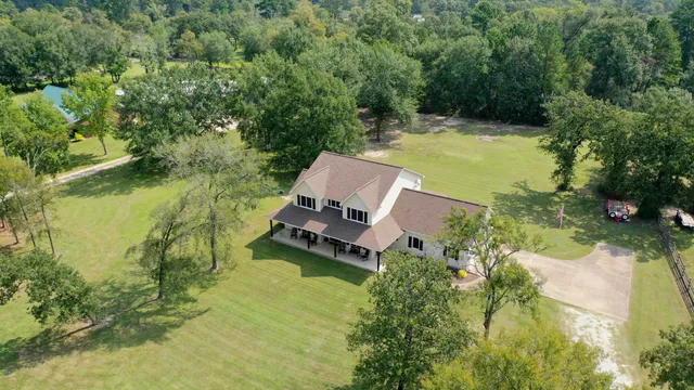 an aerial view of a house with a garden and swimming pool
