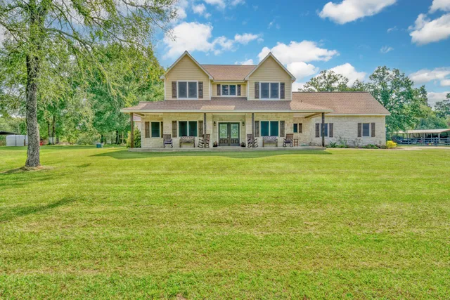 a front view of a house with a garden