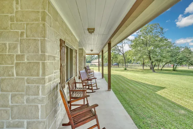 a swimming pool with outdoor seating and yard