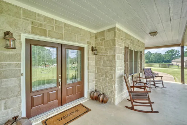 a living room with furniture and a floor to ceiling window