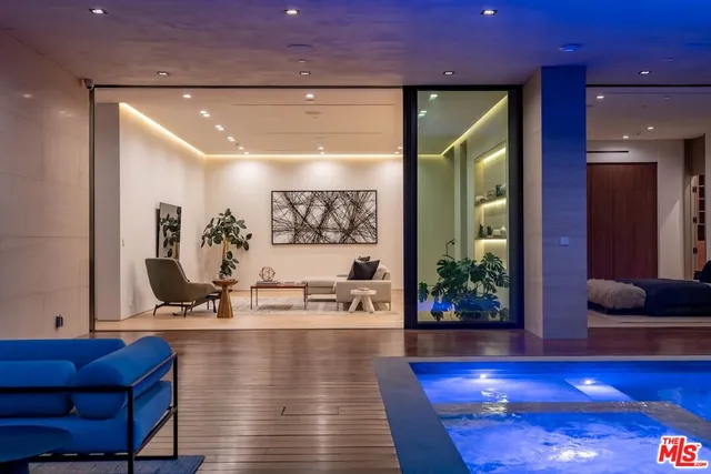 a living room with a large window and a bed