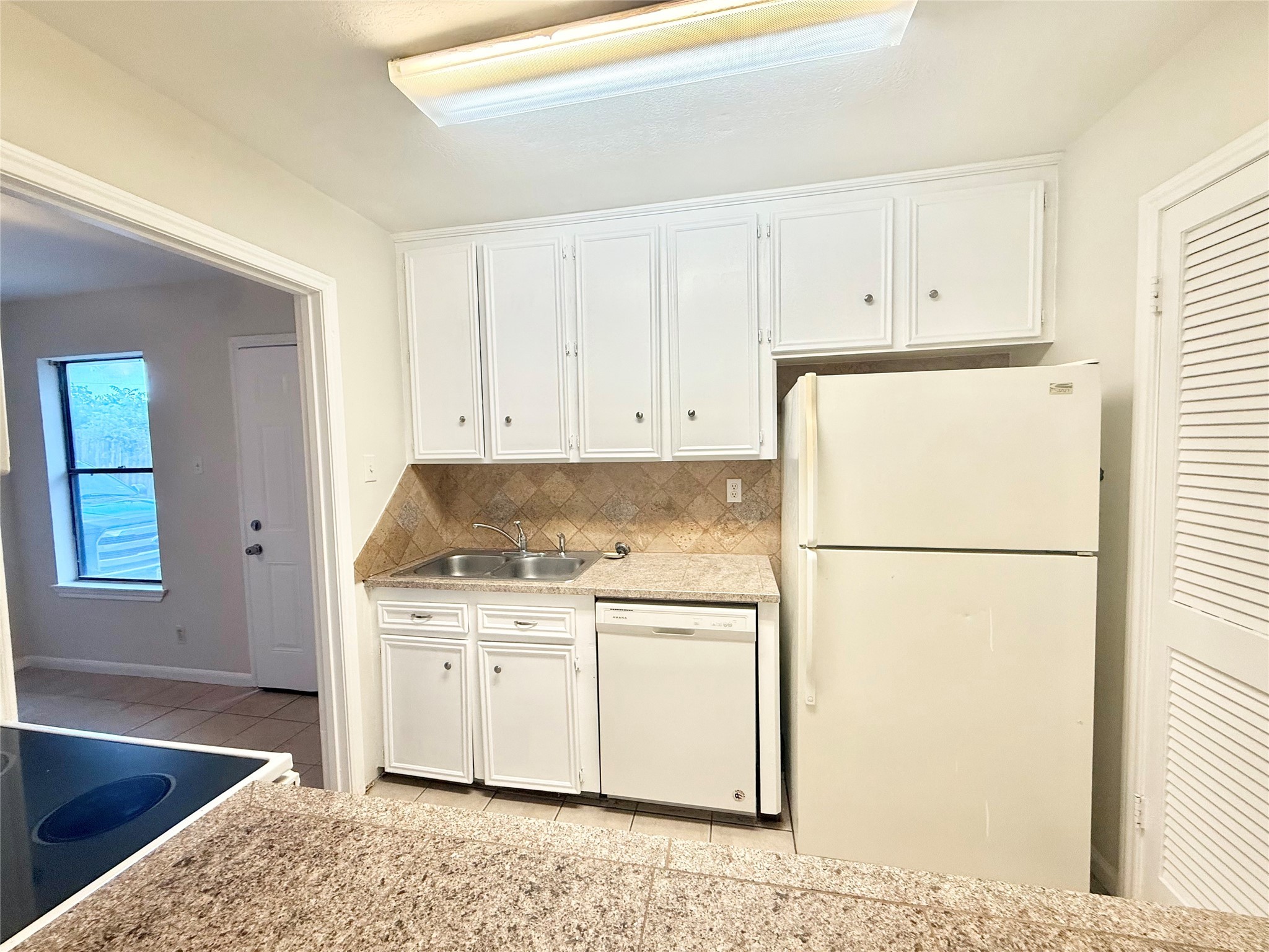 8915 Emnora Lane, Unit C Houston, TX 77080 - Photo 8 of 12 Kitchen includes a refrigerator and has tile countertops