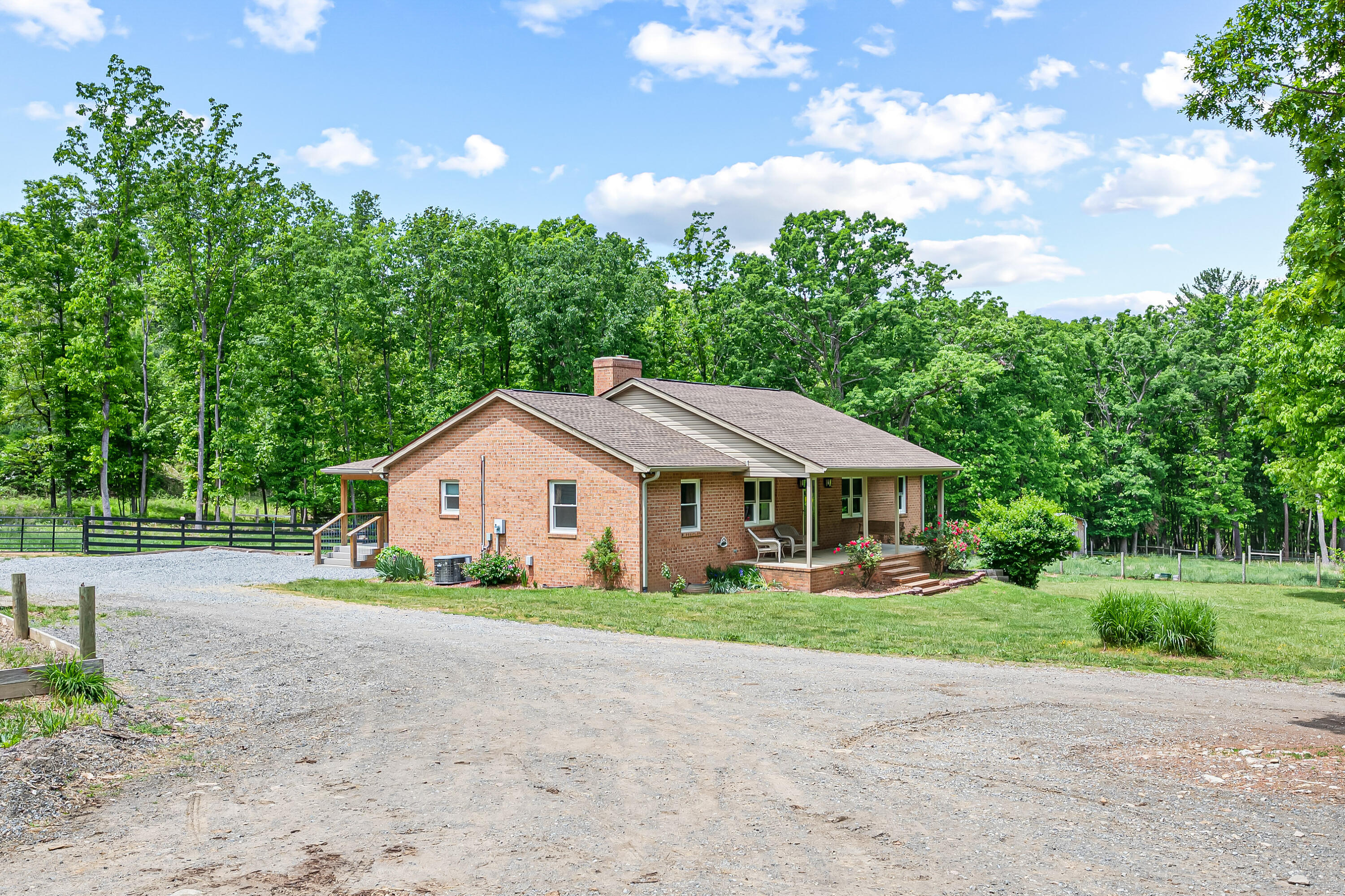 1365 Brake Road Elliston, VA 24087 - Photo 1 of 98 a front view of a house with a garden and yard