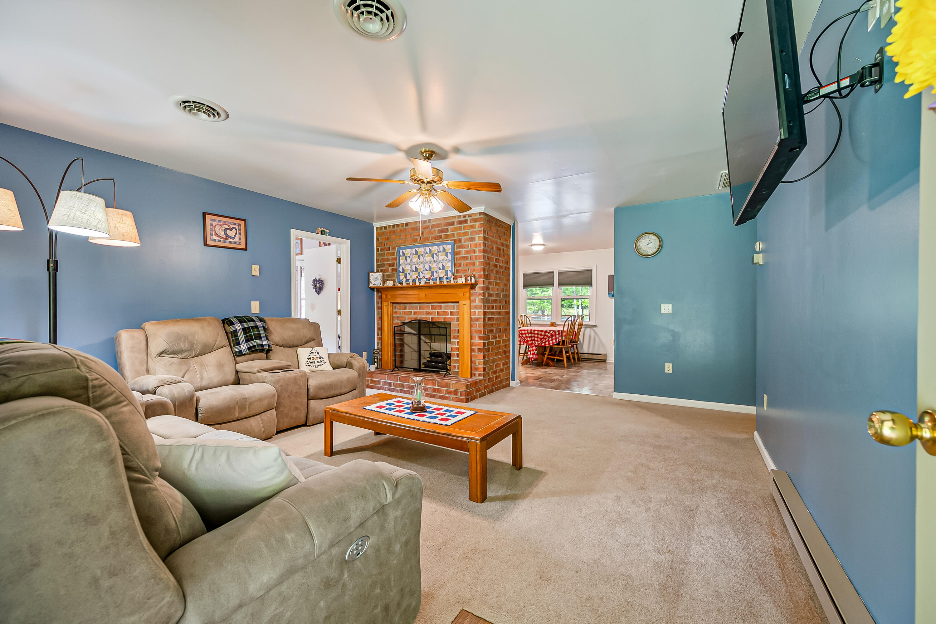 1365 Brake Road Elliston, VA 24087 - Photo 11 of 98 a living room with furniture a fireplace and a chandelier