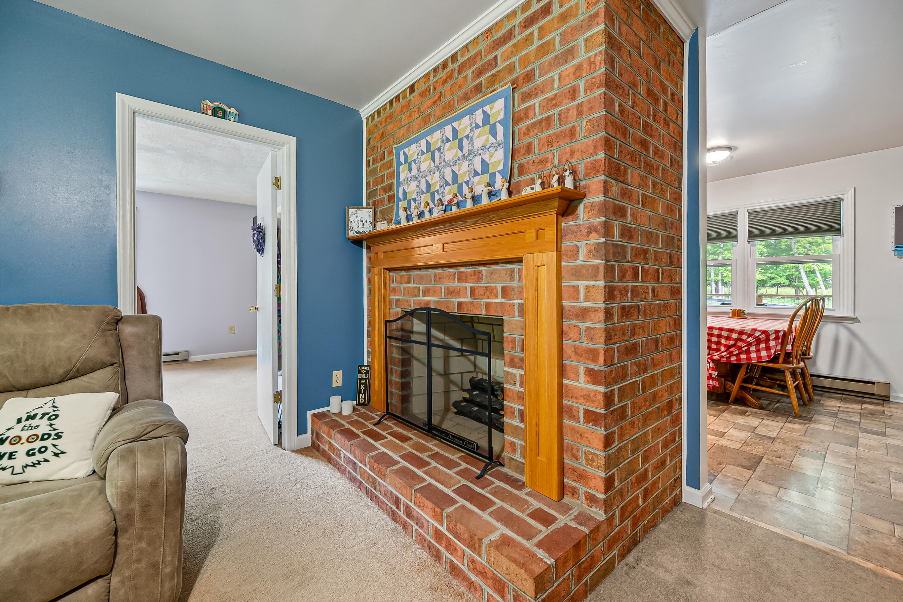1365 Brake Road Elliston, VA 24087 - Photo 15 of 98 a living room with furniture a fireplace and a dining table