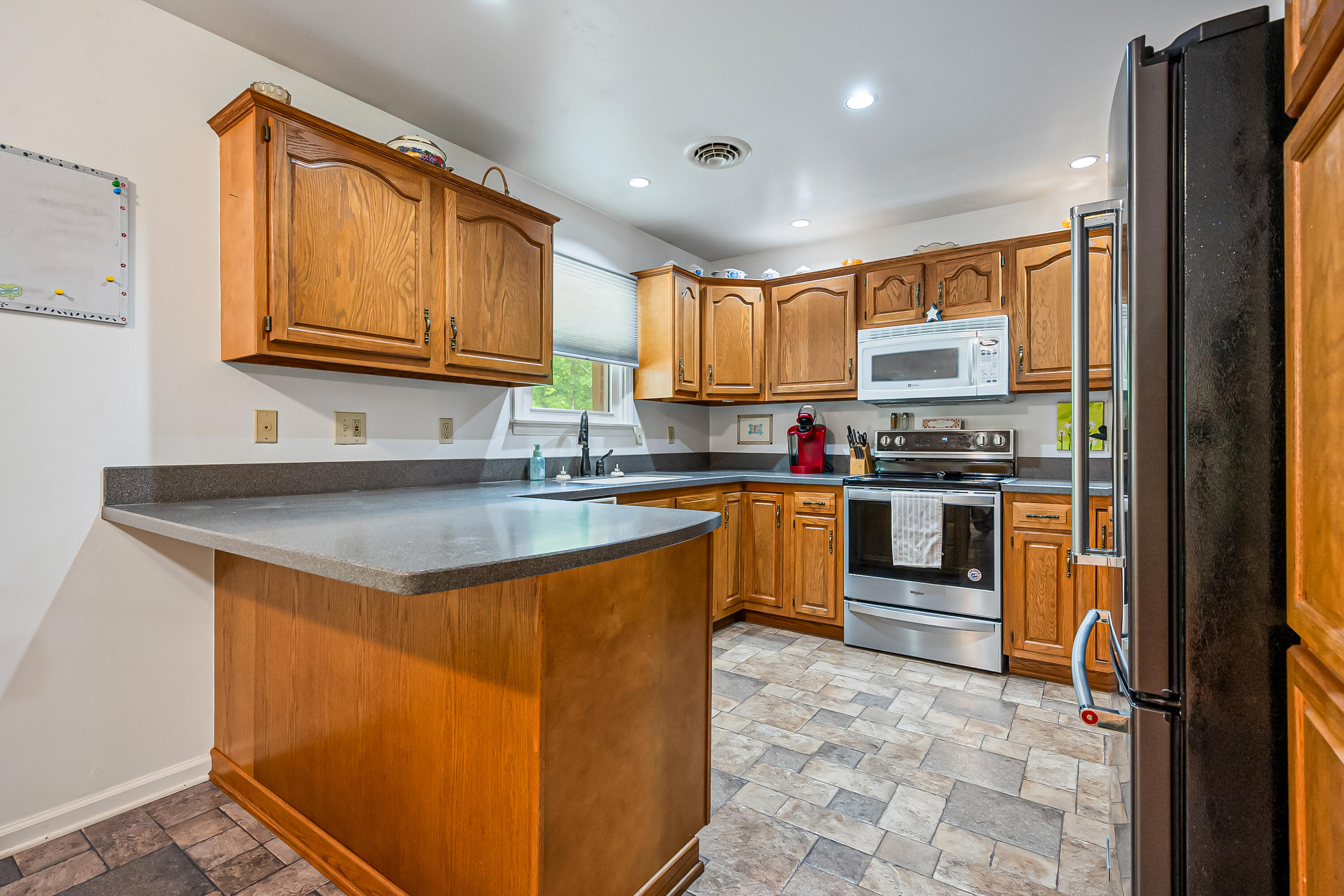 1365 Brake Road Elliston, VA 24087 - Photo 23 of 98 a kitchen with stainless steel appliances granite countertop a sink stove and cabinets