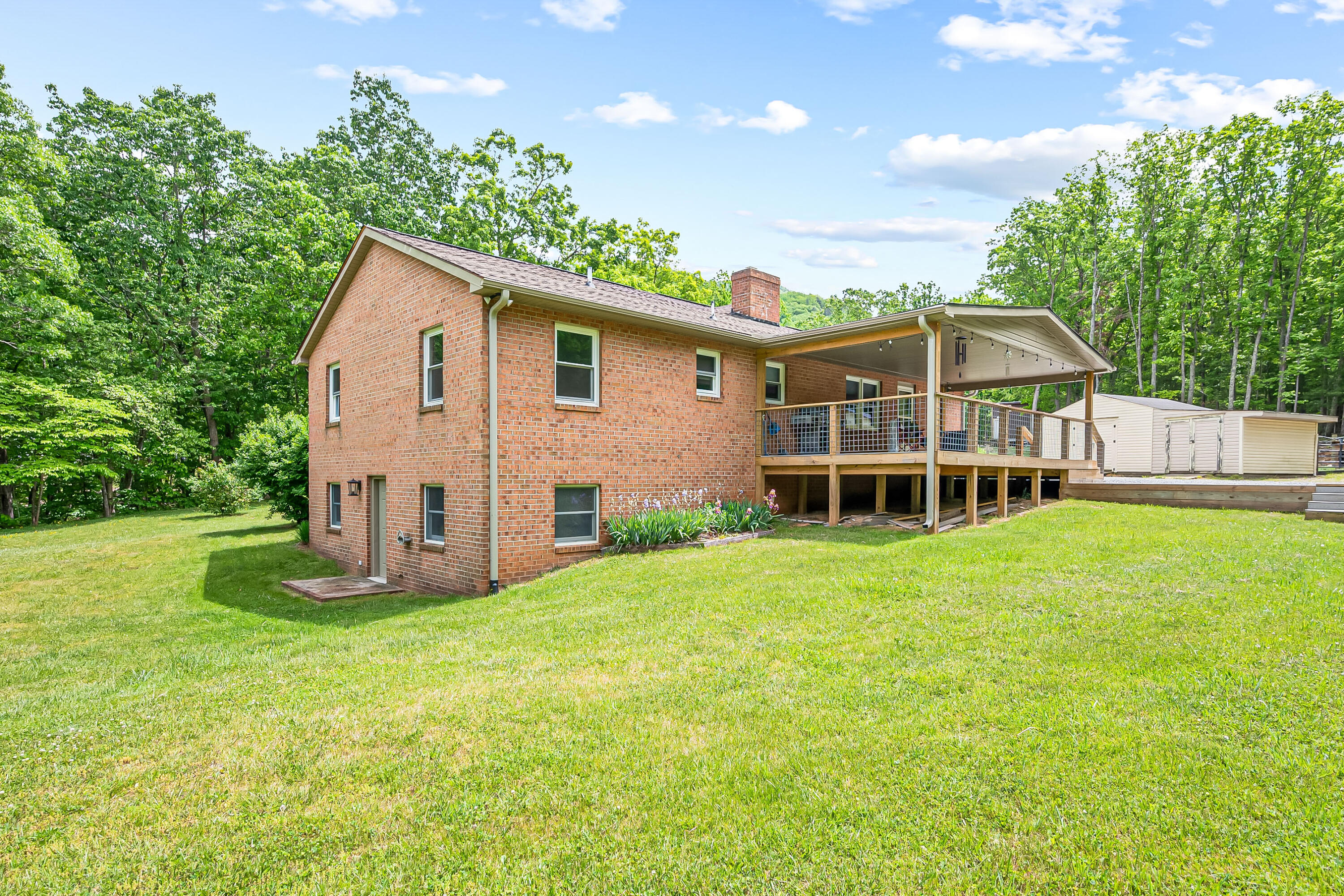 1365 Brake Road Elliston, VA 24087 - Photo 64 of 98 a view of a house with a yard and potted plants