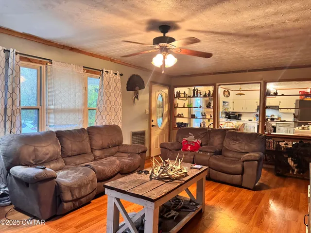 a kitchen with stainless steel appliances granite countertop a sink a stove a refrigerator and cabinets