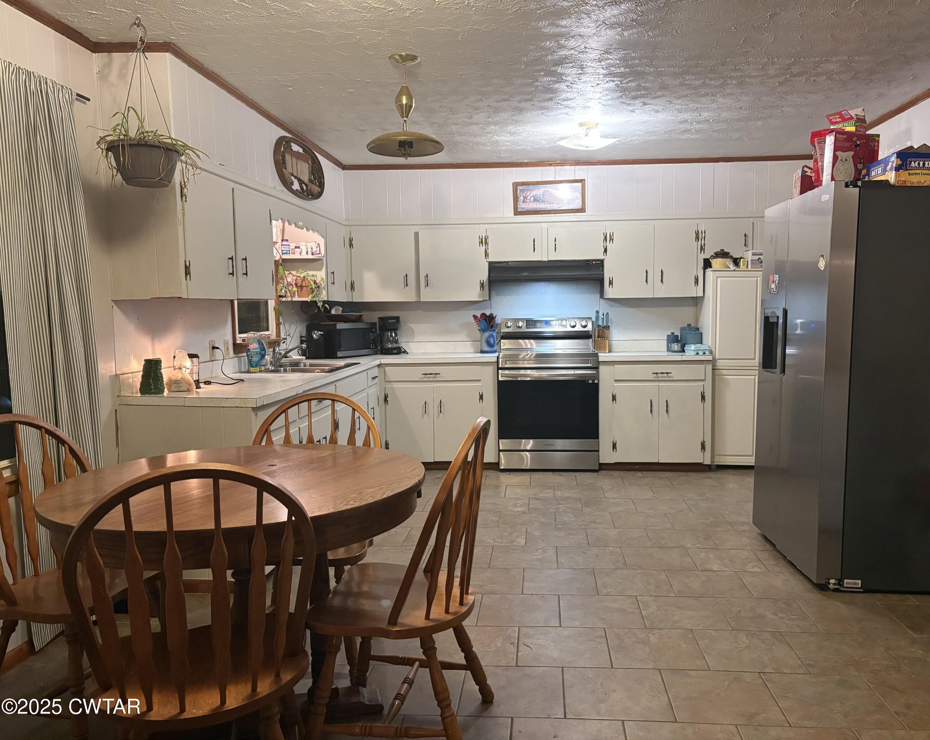 2727 Marvin Vaught Road Troy, TN 38260 - Photo 5 of 19 a kitchen with stainless steel appliances granite countertop a sink a stove a refrigerator and cabinets