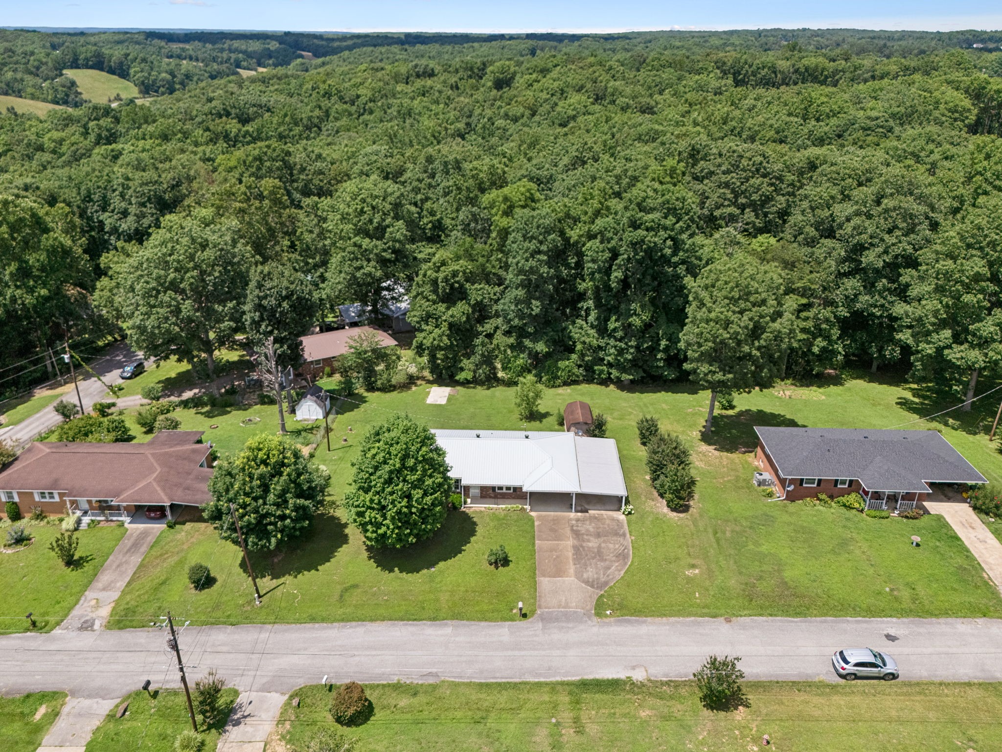 708 Hickory Street Centerville, TN 37033 - Photo 40 of 57 an aerial view of residential houses with outdoor space and trees