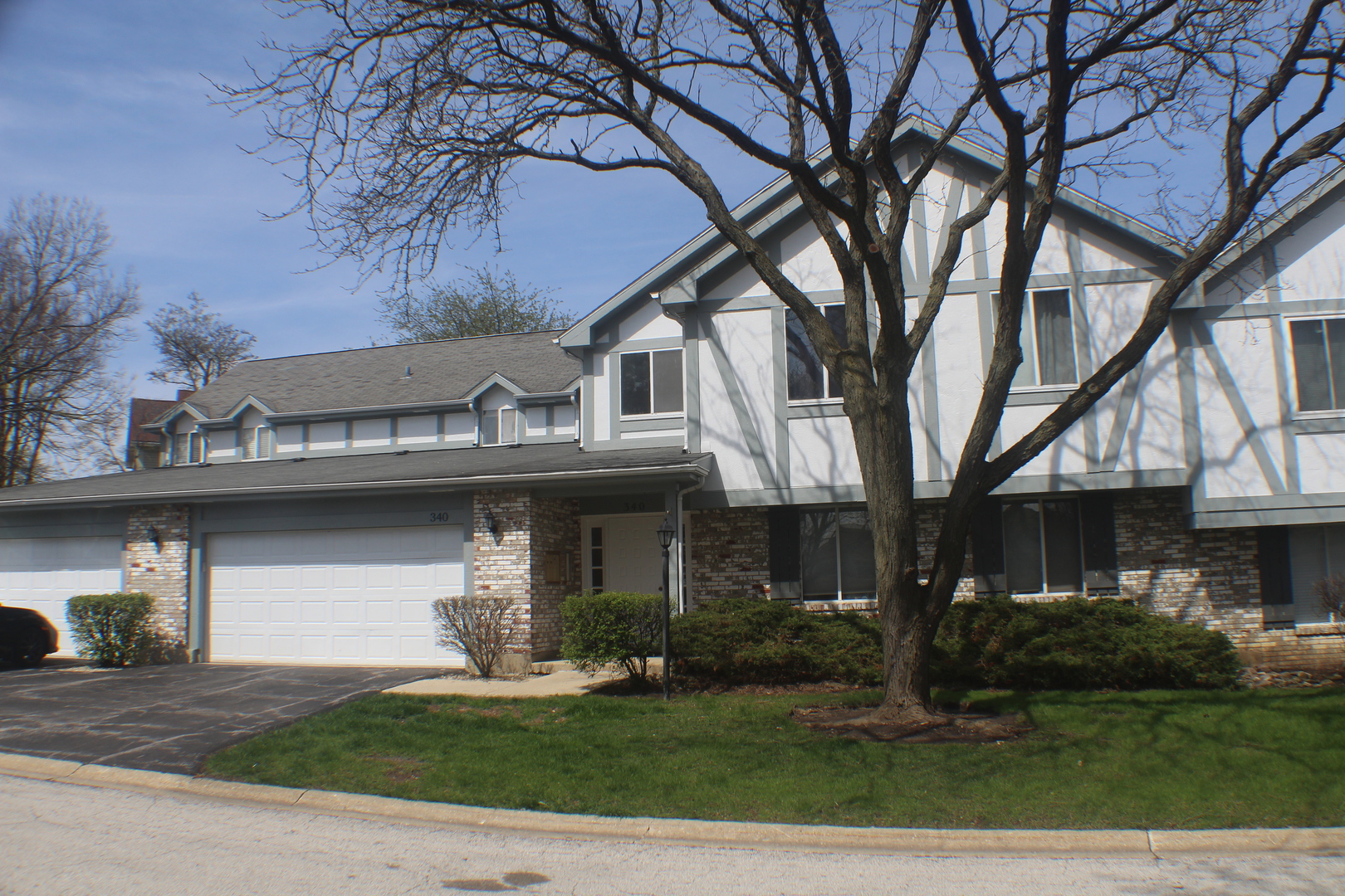 340 Springlake Lane, Unit D Aurora, IL 60504 - Photo 16 of 16 a front view of a house with a garden and trees