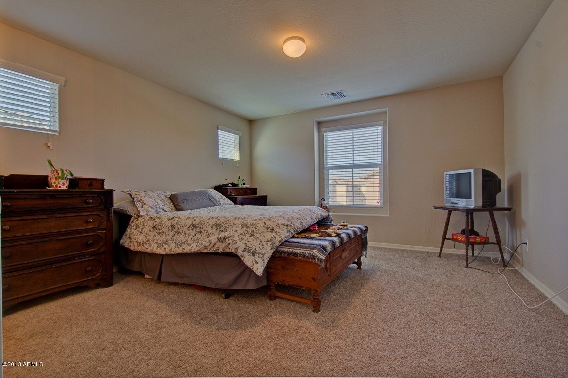 4073 East Tulsa Street Gilbert, AZ 85295 - Photo 17 of 33 a bedroom with a bed a dresser and chair