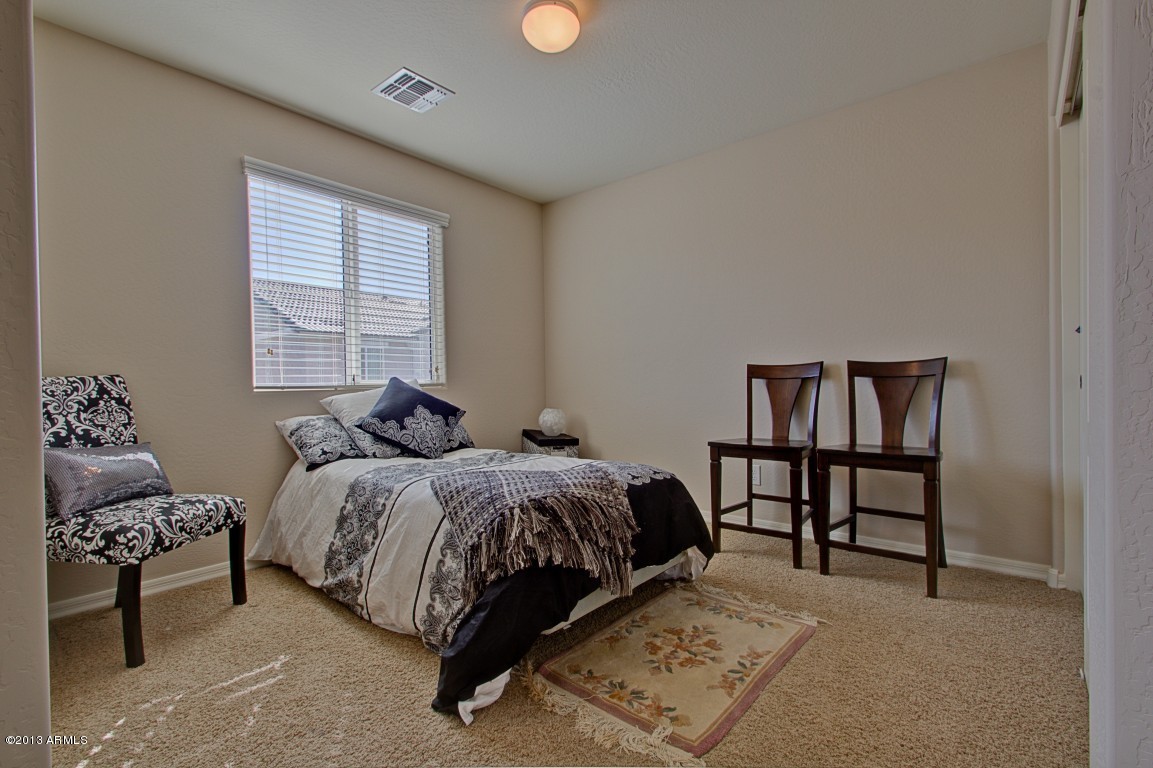 4073 East Tulsa Street Gilbert, AZ 85295 - Photo 26 of 33 a bed room with a bed and a book shelf