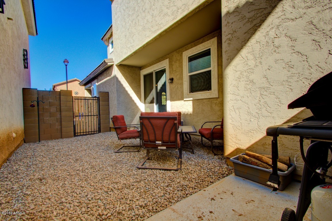 4073 East Tulsa Street Gilbert, AZ 85295 - Photo 31 of 33 a backyard of a house with barbeque oven table and chairs