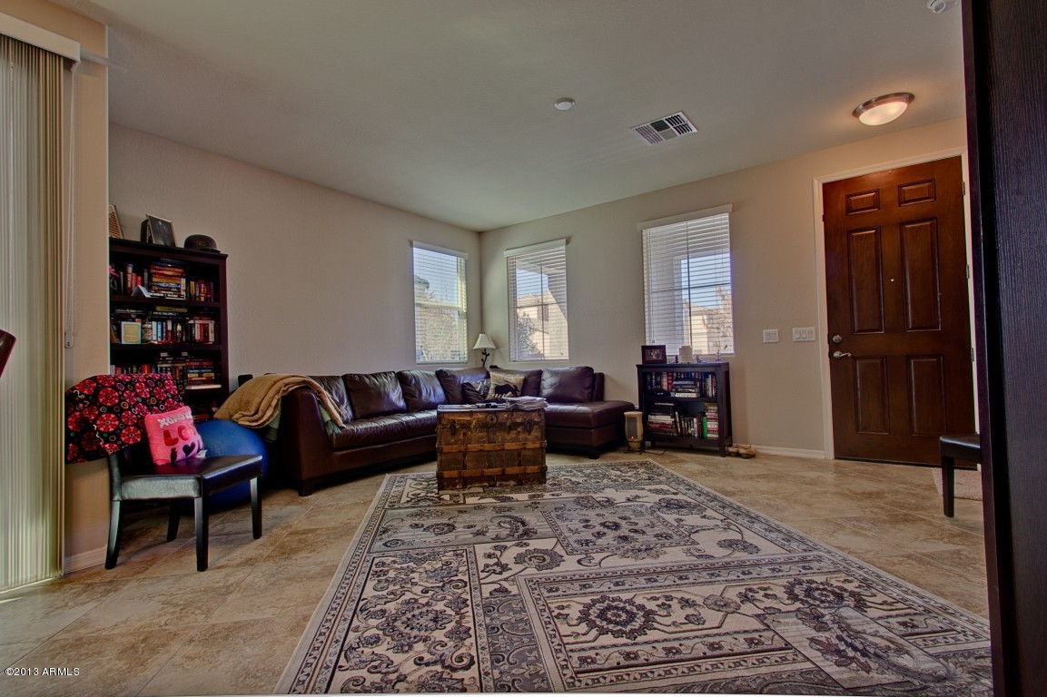 4073 East Tulsa Street Gilbert, AZ 85295 - Photo 5 of 33 a living room with furniture and a rug