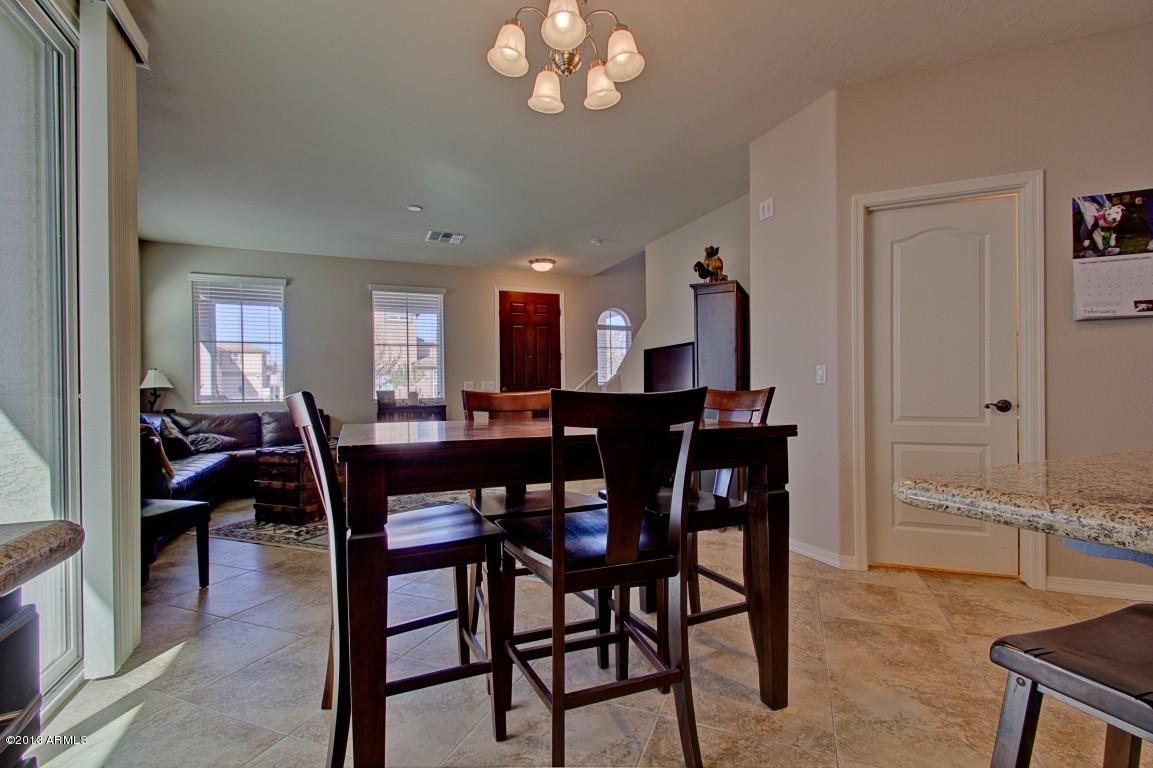 4073 East Tulsa Street Gilbert, AZ 85295 - Photo 9 of 33 a view of a dining room with furniture and chandelier