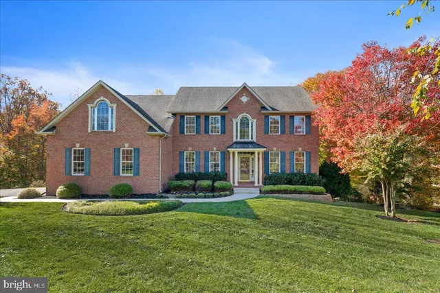 a front view of a house with a yard and potted plants