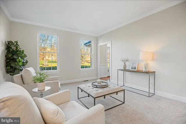 a living room with fireplace furniture and a large window