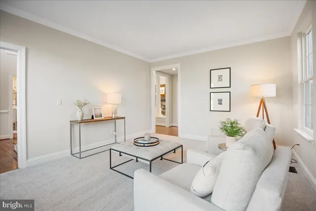 a living room with furniture fireplace and large windows