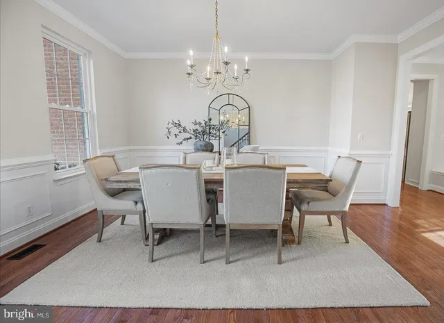 a living room with furniture fireplace and a large window