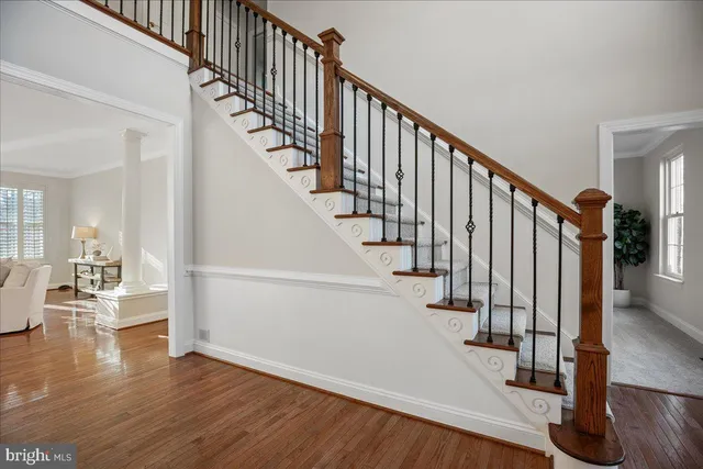 a dining room with furniture a chandelier and wooden floor