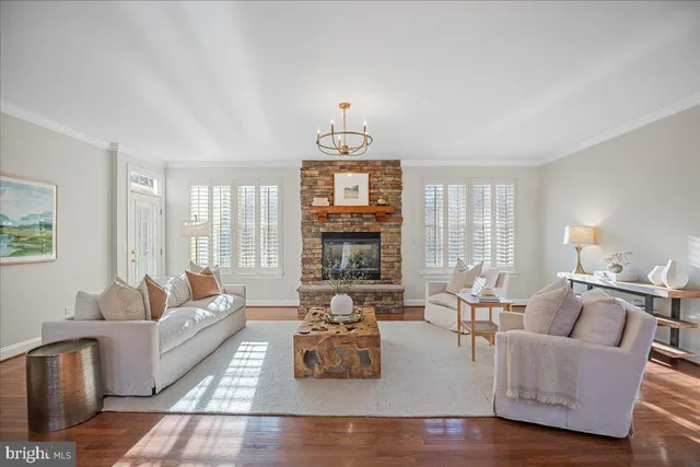 a view of a hallway with wooden floor and a chandelier