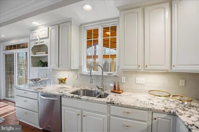a kitchen with stainless steel appliances granite countertop a sink and cabinets