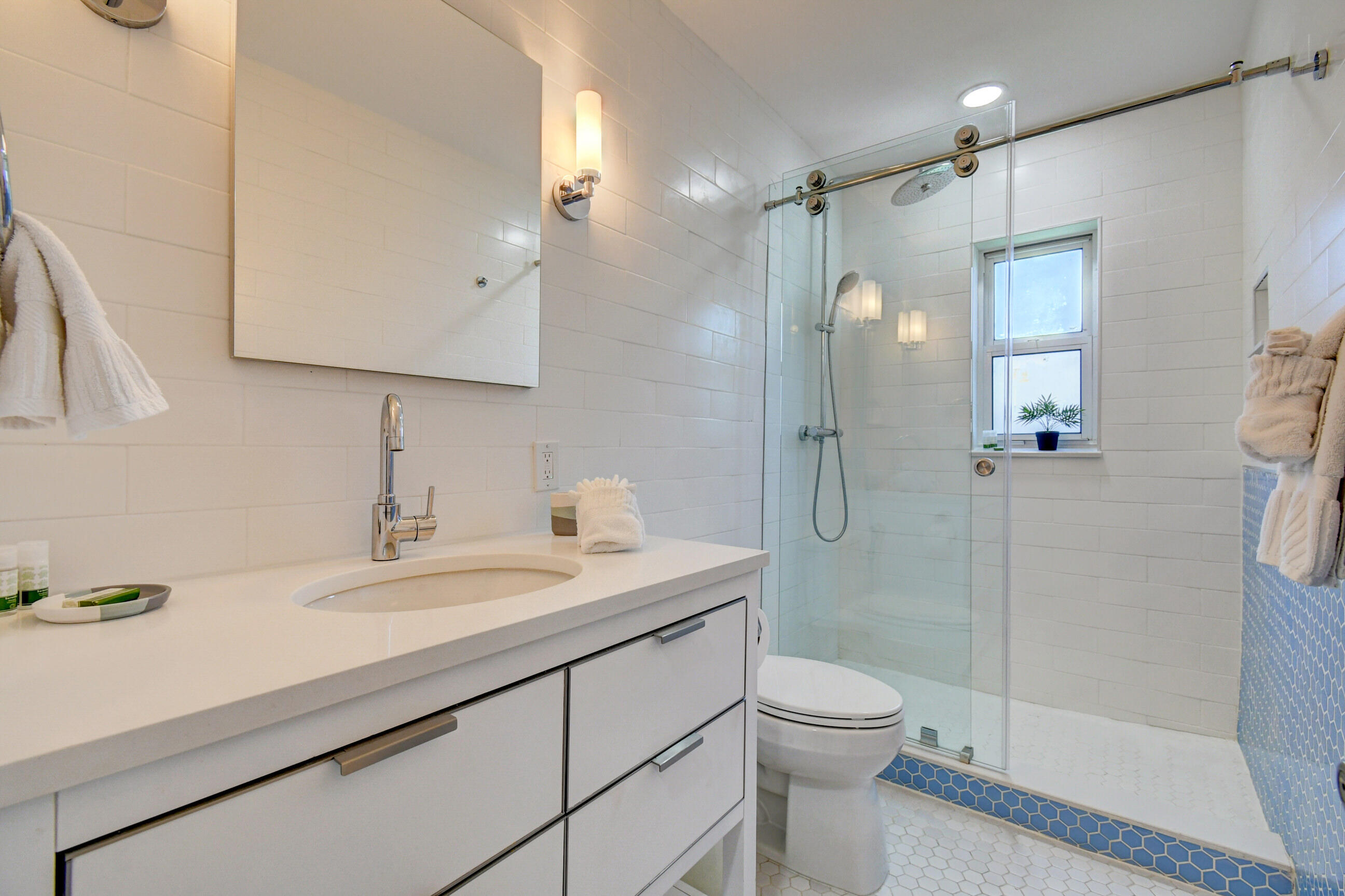 309 Rilyn Drive West Palm Beach, FL 33405 - Photo 16 of 26 a bathroom with a shower sink vanity mirror and toilet