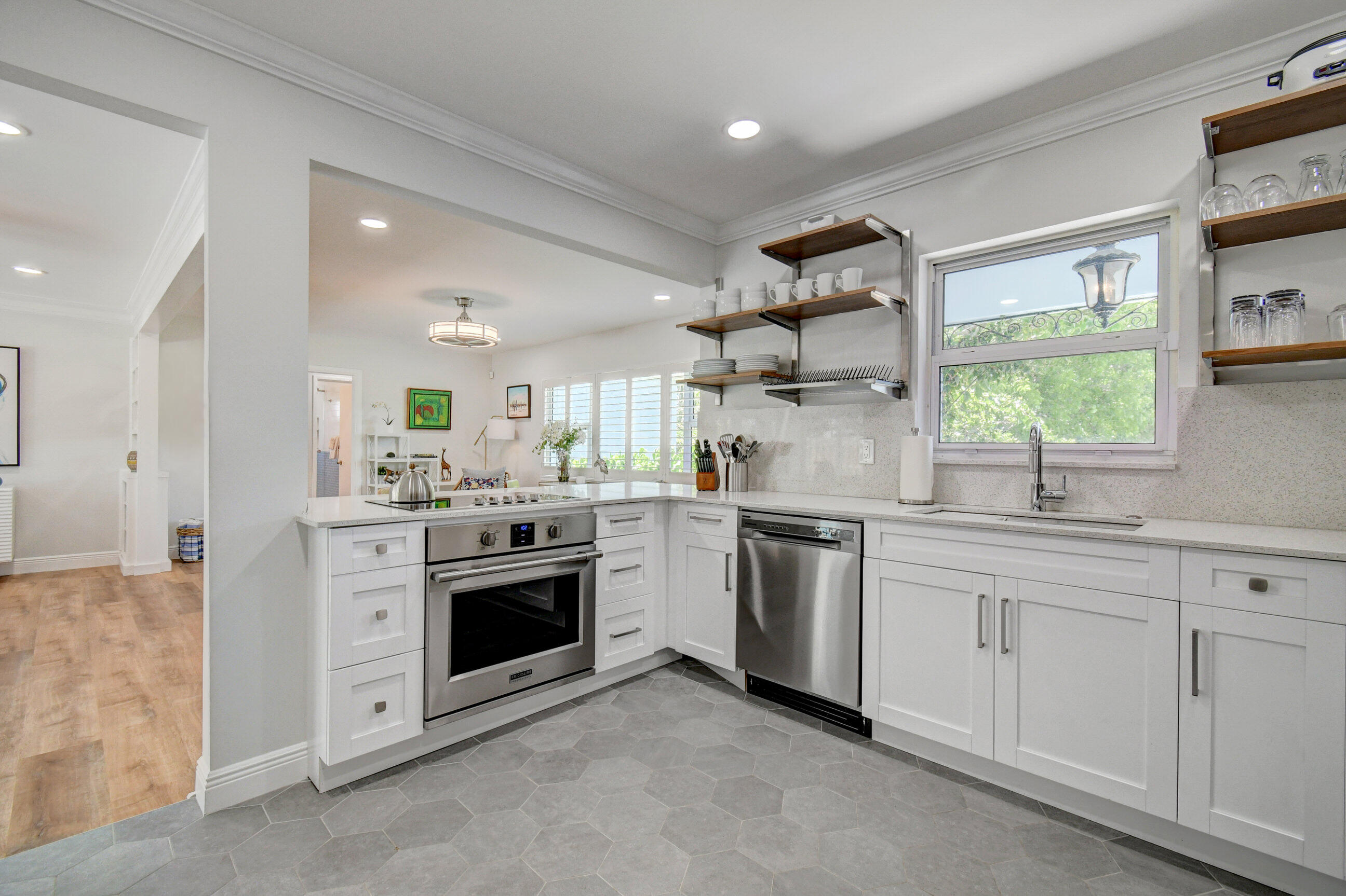 309 Rilyn Drive West Palm Beach, FL 33405 - Photo 2 of 26 a kitchen with white cabinets and stainless steel appliances