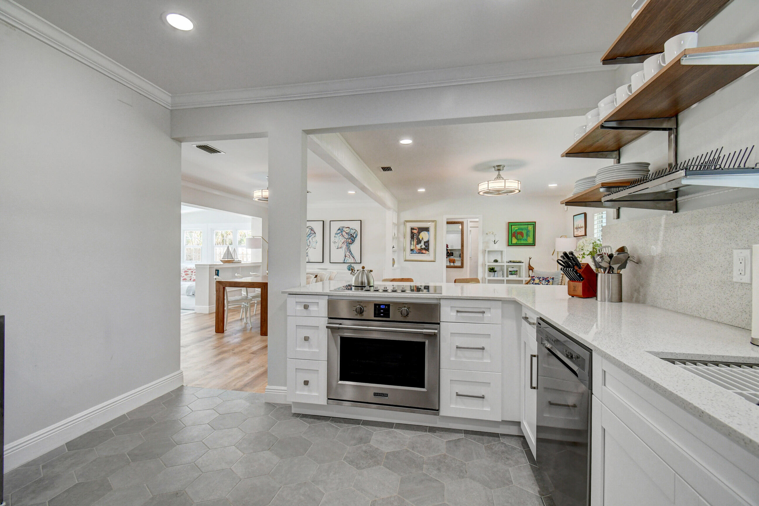 309 Rilyn Drive West Palm Beach, FL 33405 - Photo 3 of 26 a kitchen with stainless steel appliances granite countertop a stove and white cabinets