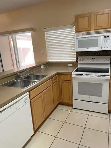 a kitchen with a stove sink and cabinets