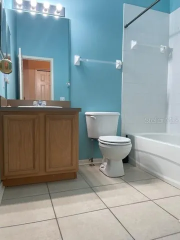 a bathroom with a sink toilet and mirror