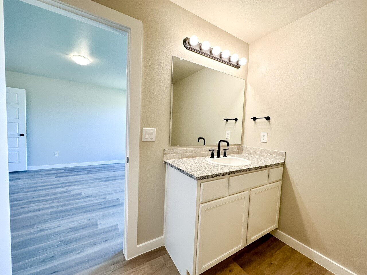 6928 10th Street Lubbock, TX 79416 - Photo 15 of 23 a bathroom with a sink and a mirror