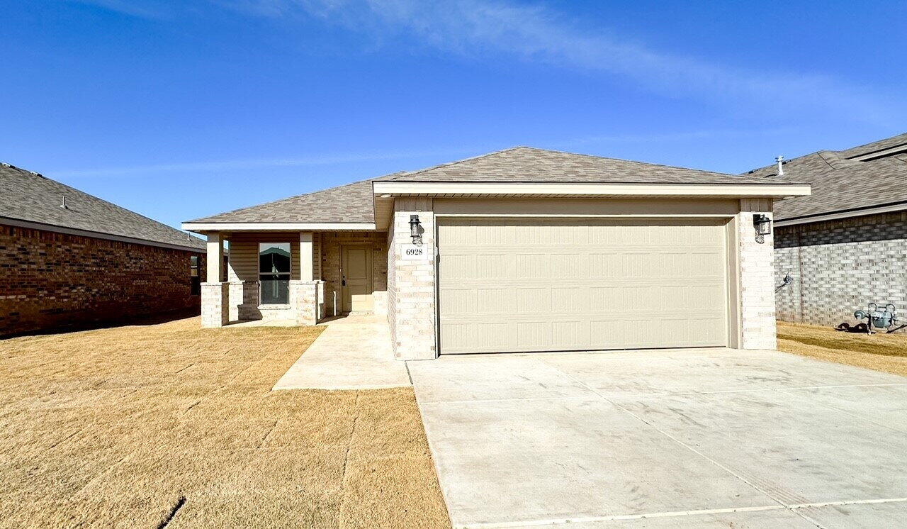 6928 10th Street Lubbock, TX 79416 - Photo 2 of 23 a front view of a house with a yard