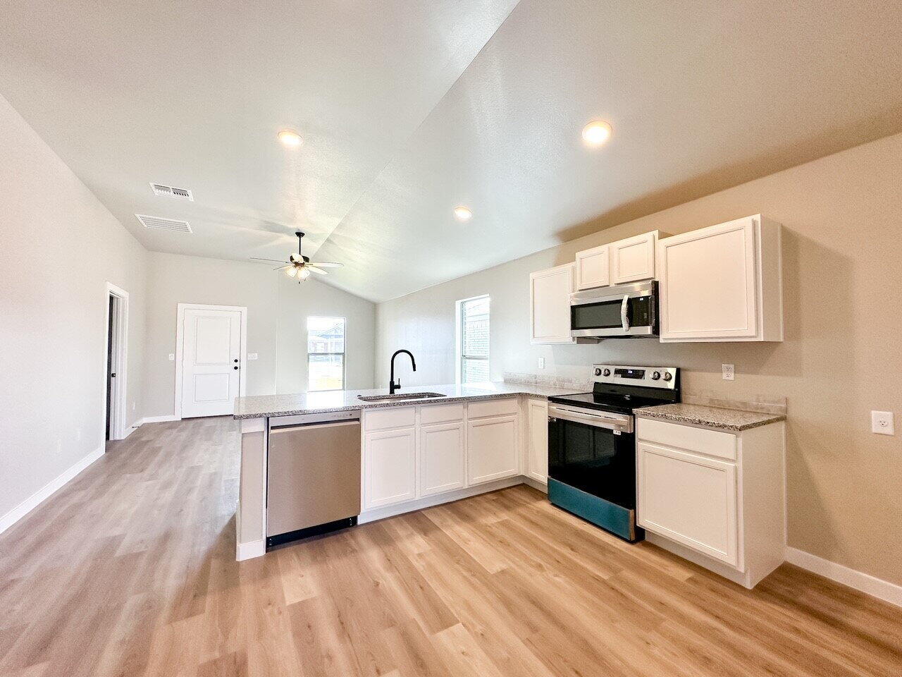 6928 10th Street Lubbock, TX 79416 - Photo 10 of 23 a large kitchen with cabinets