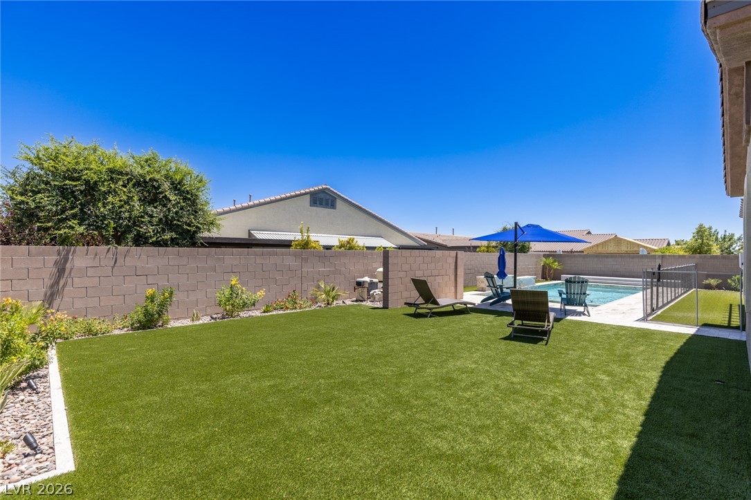 7036 Arabian Ridge Street Las Vegas, NV 89131 - Photo 50 of 64 Low maintenance turf backyard with plenty of space.