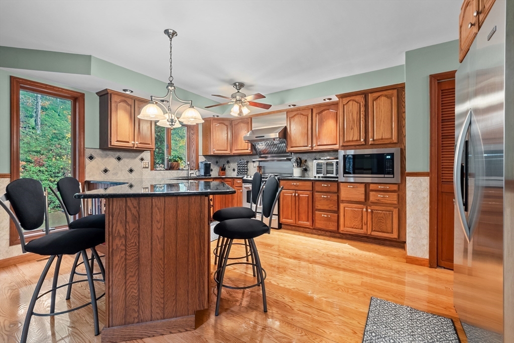 45 North Farms Road Williamsburg, MA 01039 - Photo 11 of 41 a kitchen with stainless steel appliances kitchen island granite countertop a stove a sink and a microwave