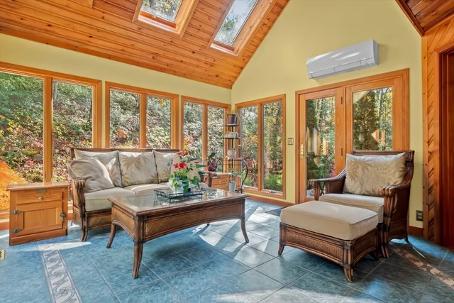 a living room with furniture a table and a large window