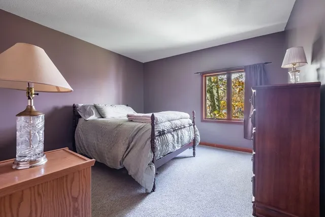 a bedroom with a bed and a lamp