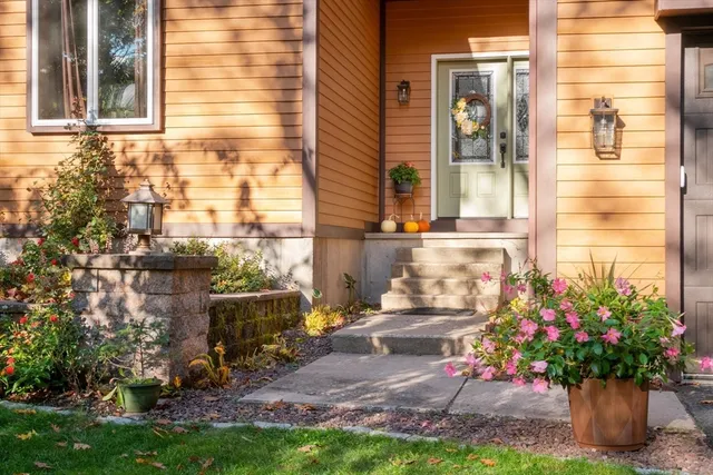 a view of a house with a yard and sitting area