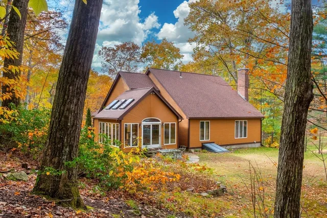 a front view of a house with a garden and yard