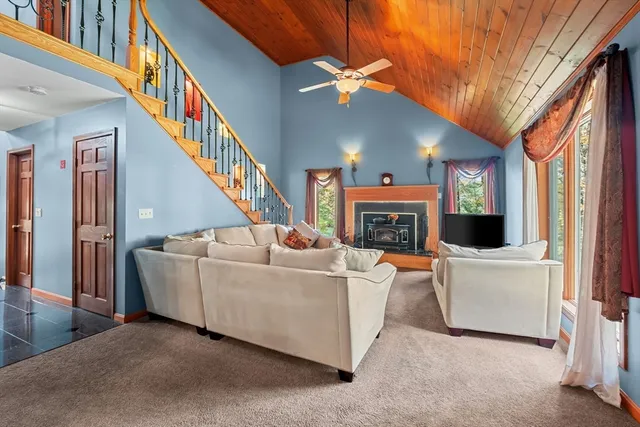 a living room with fireplace furniture and a window