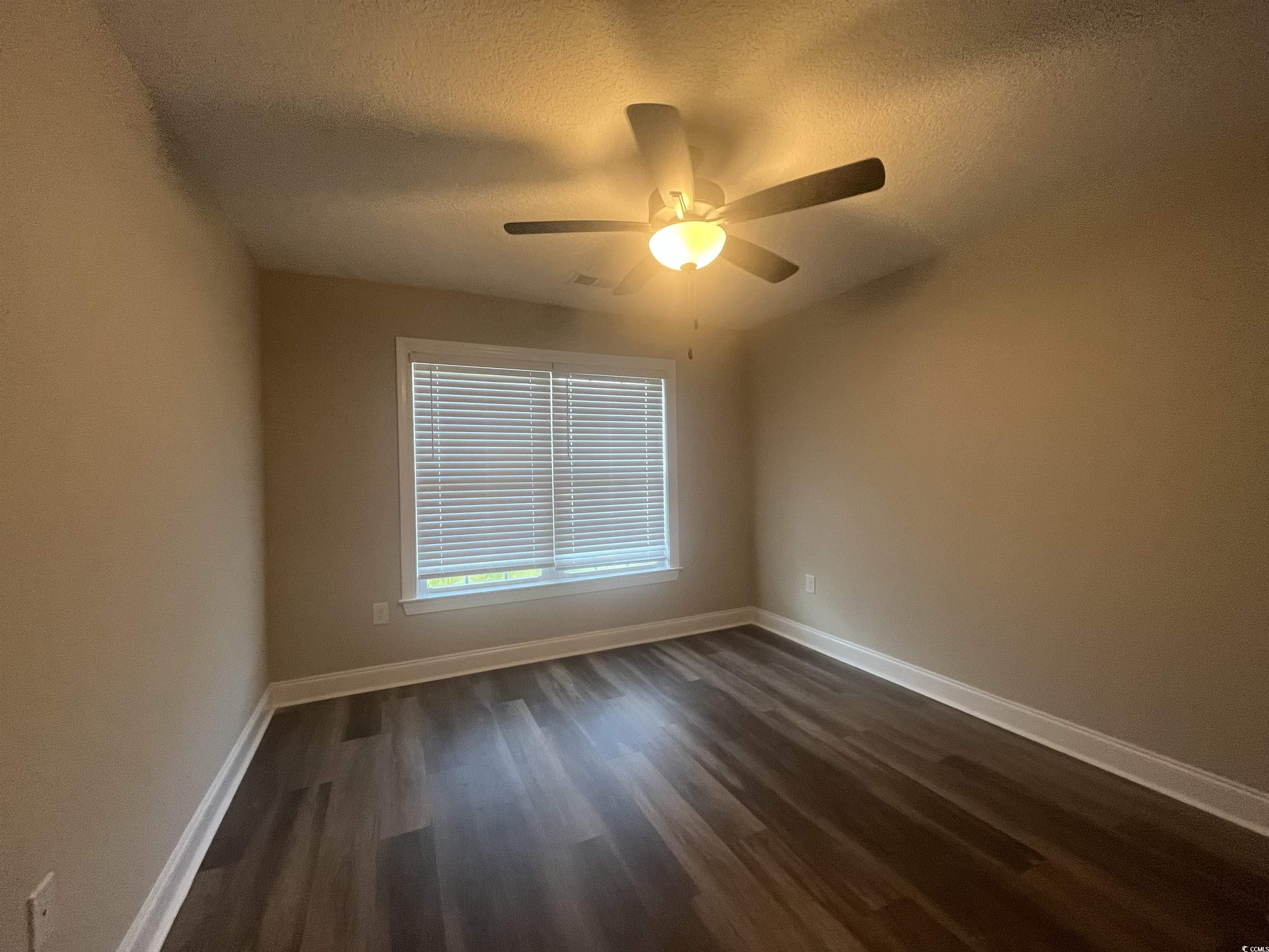 2925 Hughes Gasque Road Aynor, SC 29511 - Photo 11 of 12 Spare room featuring a textured ceiling, dark wood