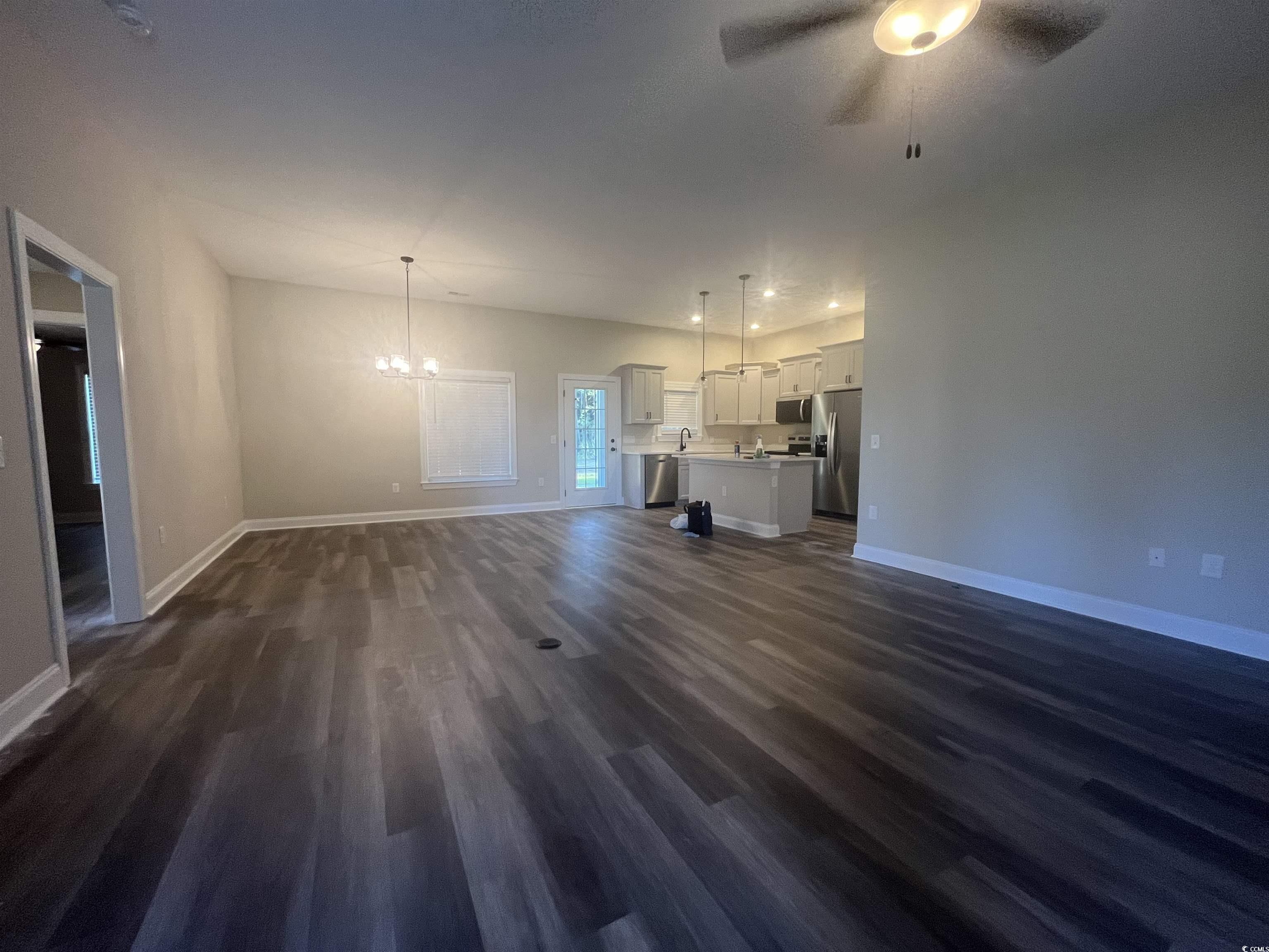 2925 Hughes Gasque Road Aynor, SC 29511 - Photo 2 of 12 Unfurnished living room with a chandelier, dark wo