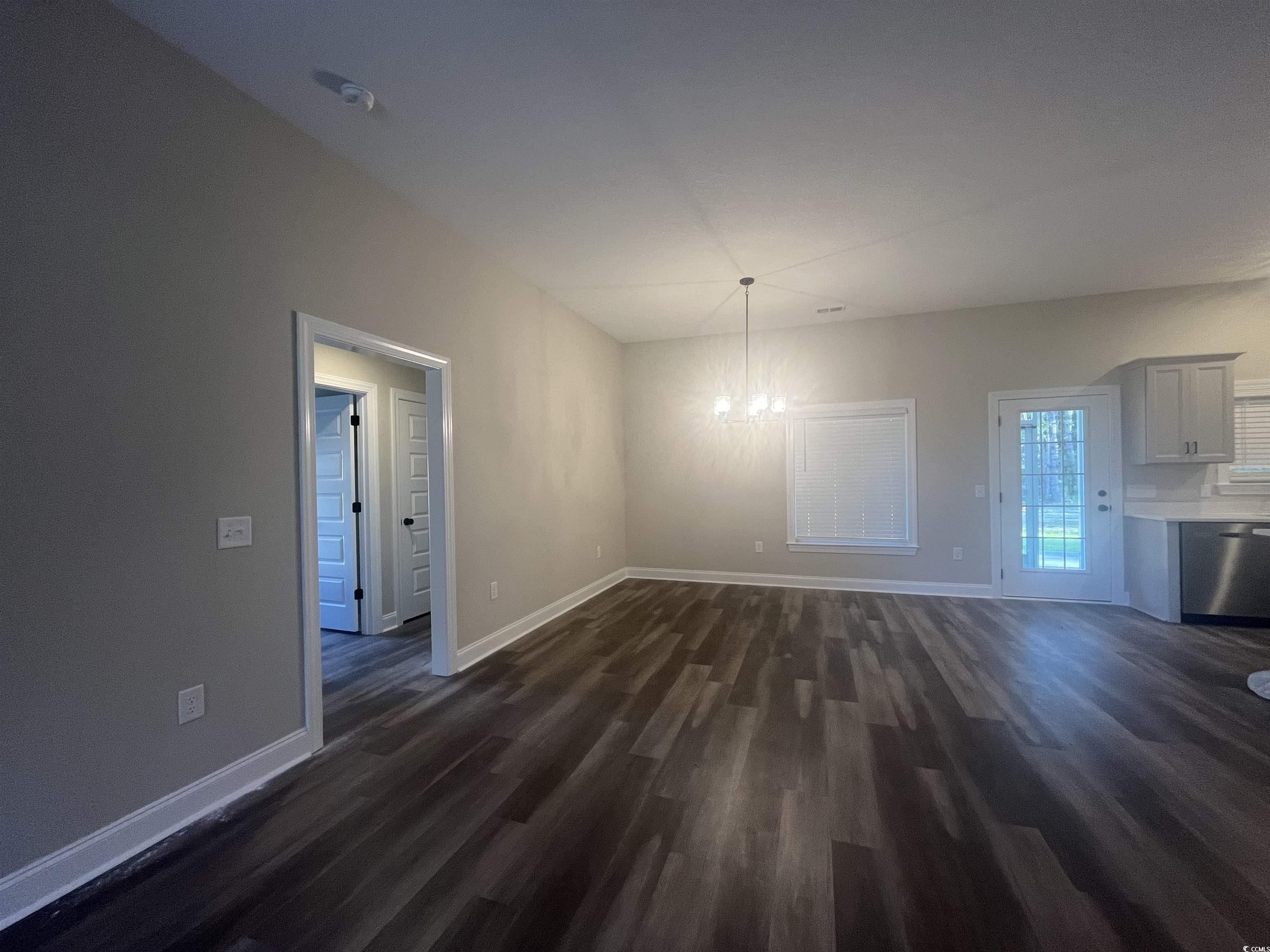 2925 Hughes Gasque Road Aynor, SC 29511 - Photo 3 of 12 Unfurnished dining area featuring dark wood finish