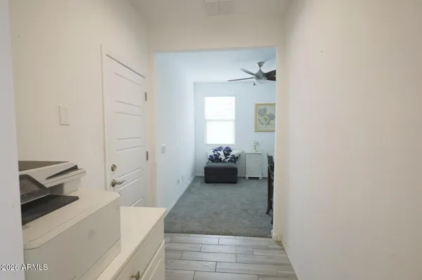 a living room with furniture flat screen tv and kitchen view