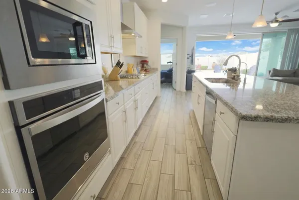 walk in closet with wooden floor washer and dryer