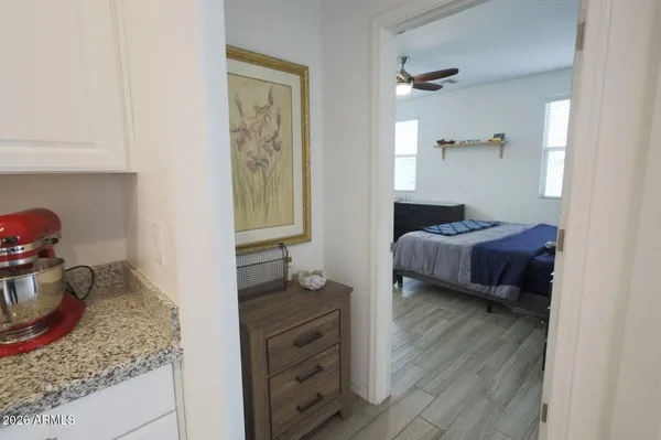 a kitchen with granite countertop a sink a counter top space and living room view